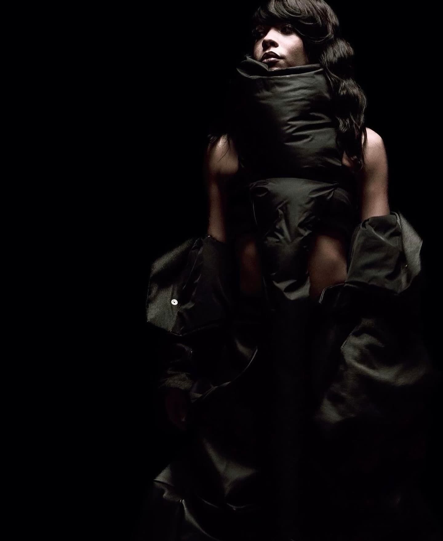 Dramatic chiaroscuro portrait with a padded wrap collar and soft-focus glam