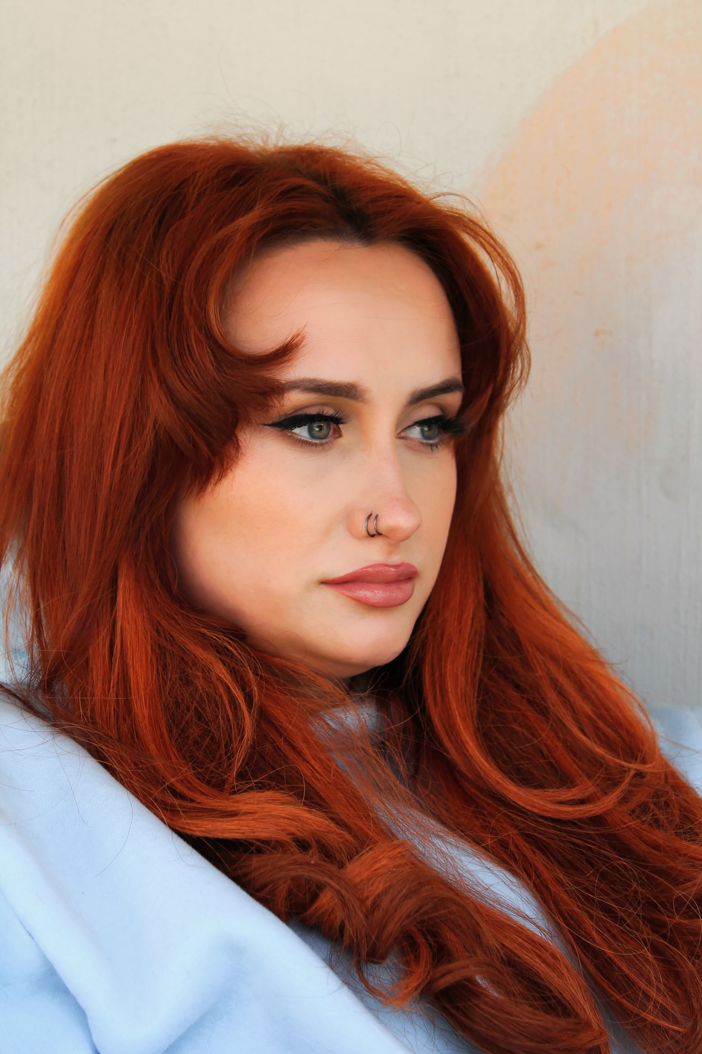 Soft-focus portrait in powder blue with a warm, diffused complexion