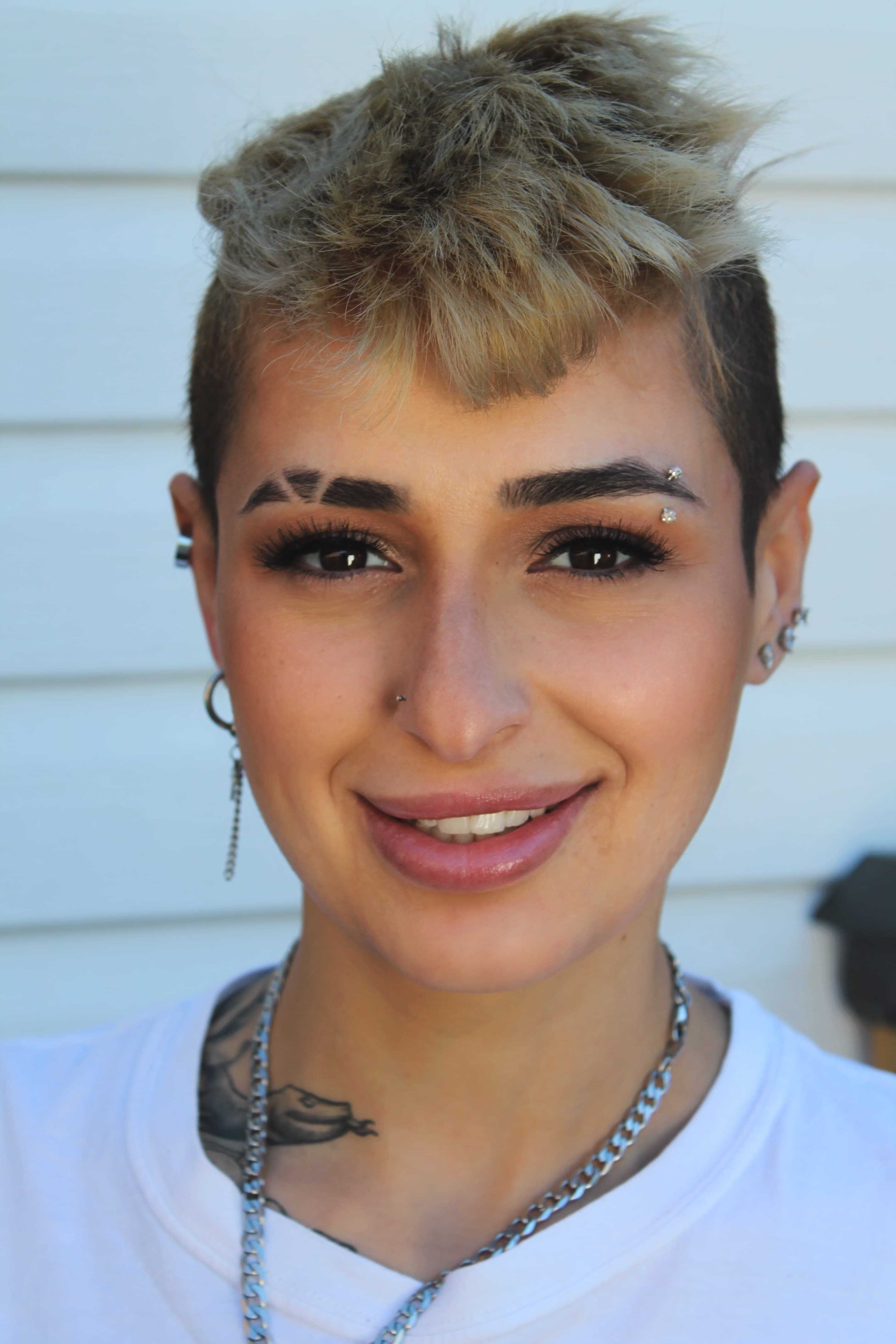 Sunlit close-up with a graphic editorial brow, feathered lash and glossy lip