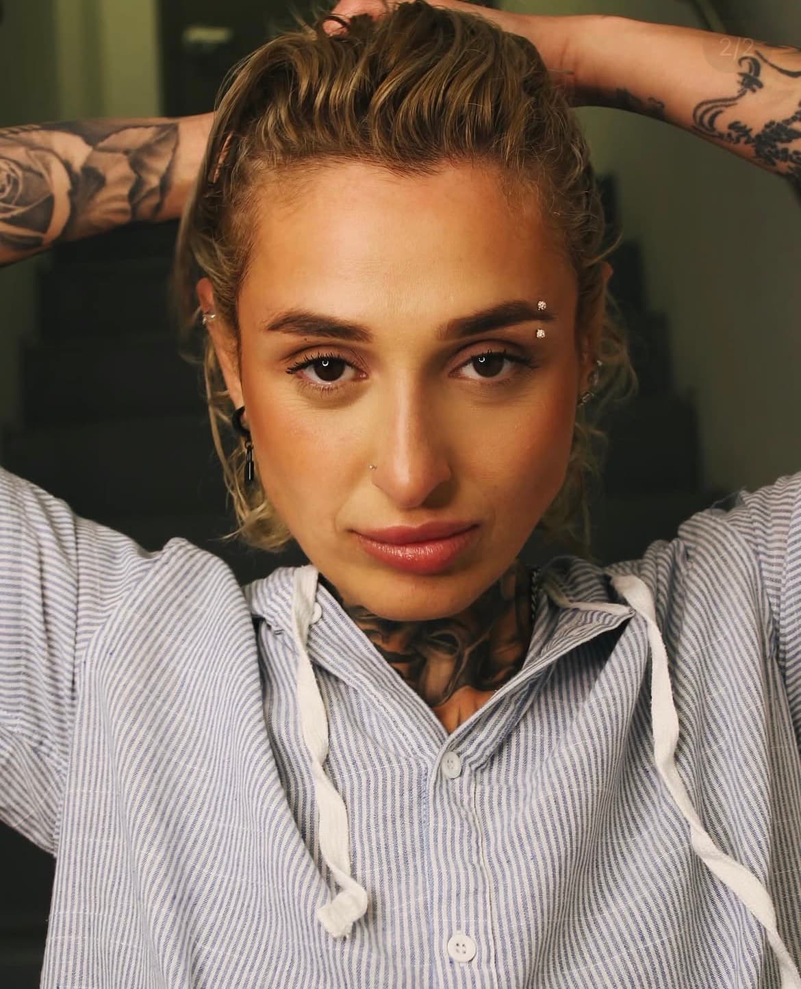 Direct-gaze portrait with defined brows and a soft matte finish